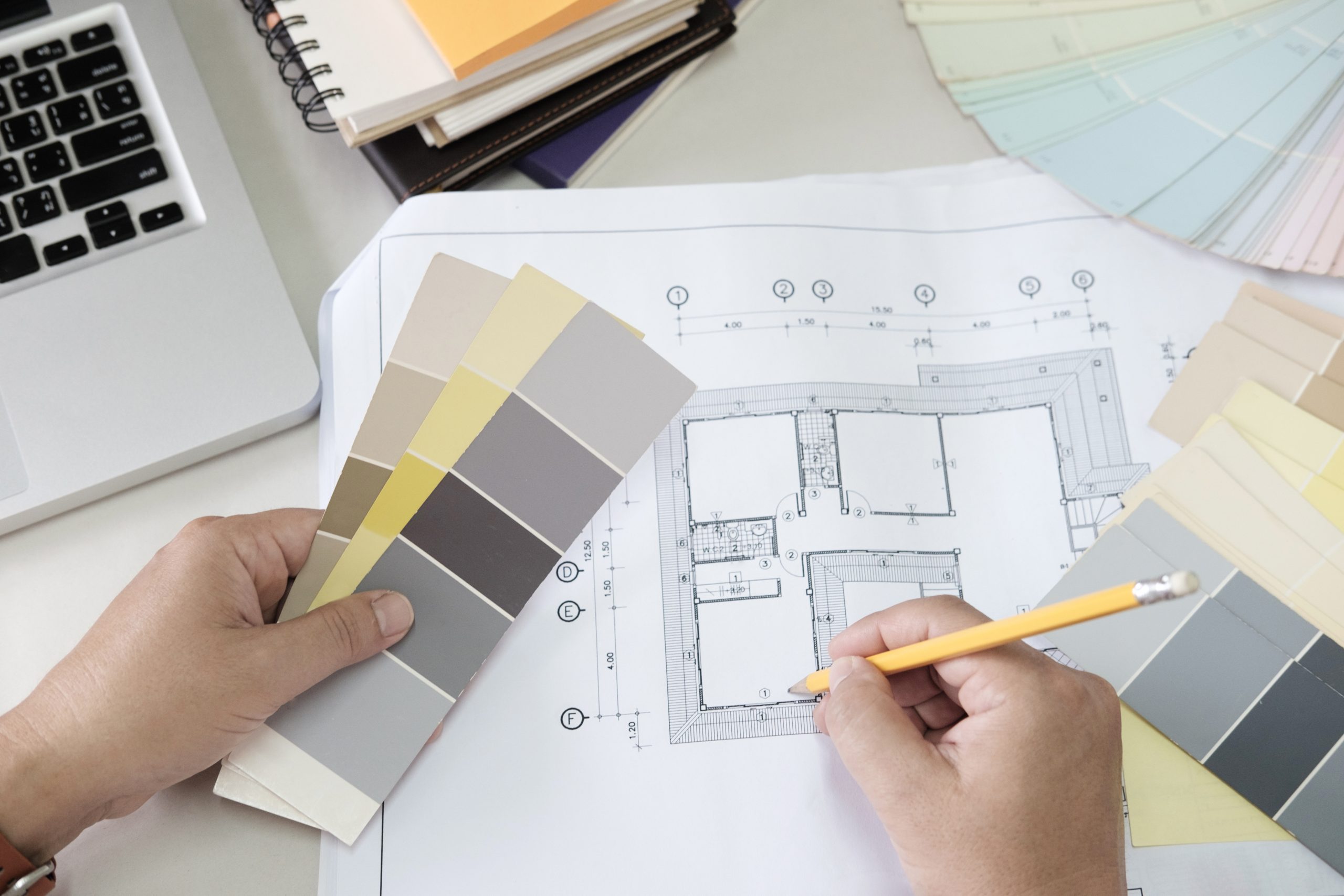 Graphic design and color swatches and pens on a desk. Architectural drawing with work tools and accessories.